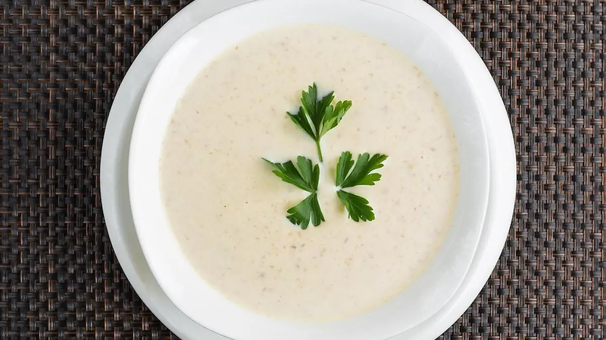 mushroom cream soup with cream in a white bowl