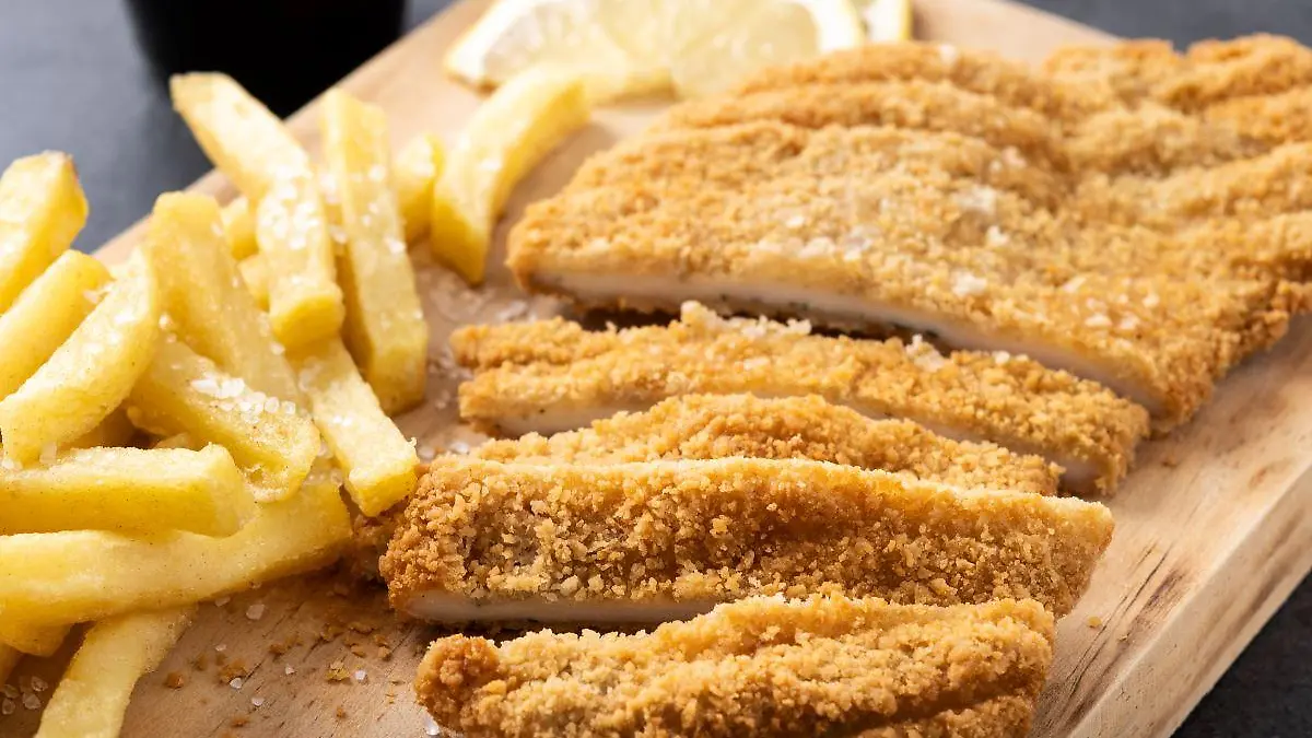 wiener schnitzel with fried potatoes black background 1 123