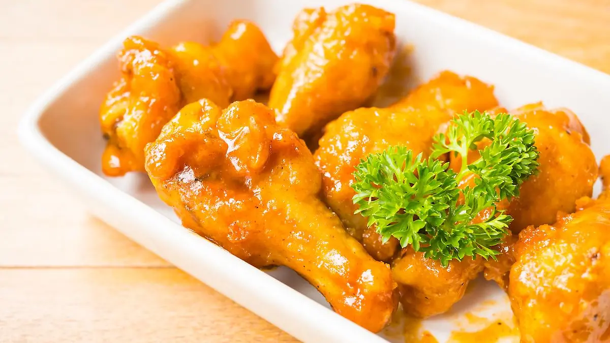 Grilled buffalo wings in white plate