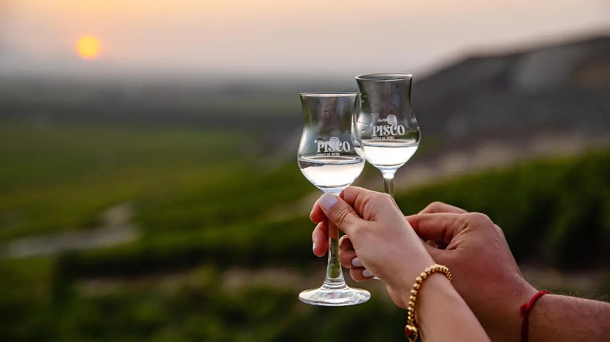 pareja brindando con copas de pisco. Marca Spirit of Peru