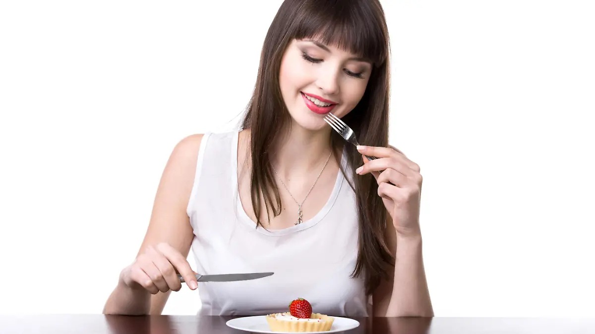 Young woman tempted to eat cake