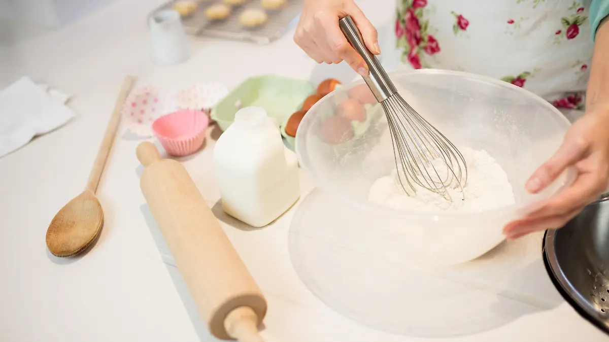 Woman whisking flour in bowl