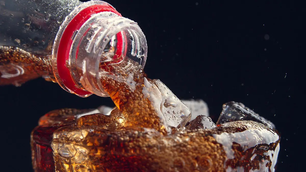 serving cola from bottle to glass full of ice 123