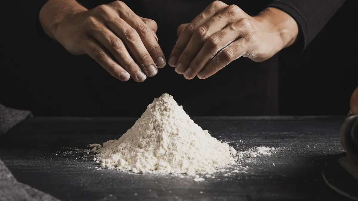 calfront view baker hands mixing flour