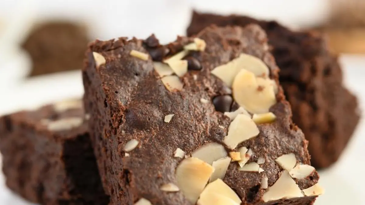 Chocolate brownies on a white plate.