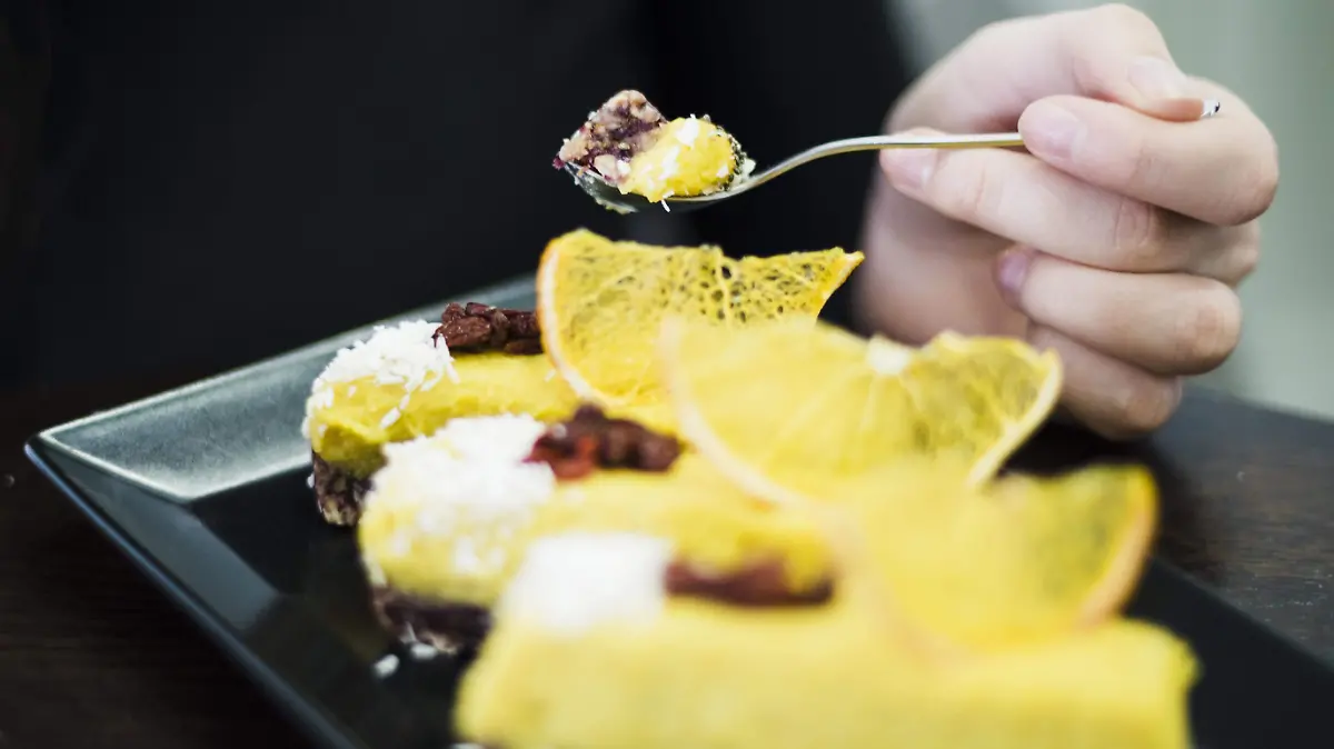 close-up-woman-s-hand-eating-cake-with-spoon