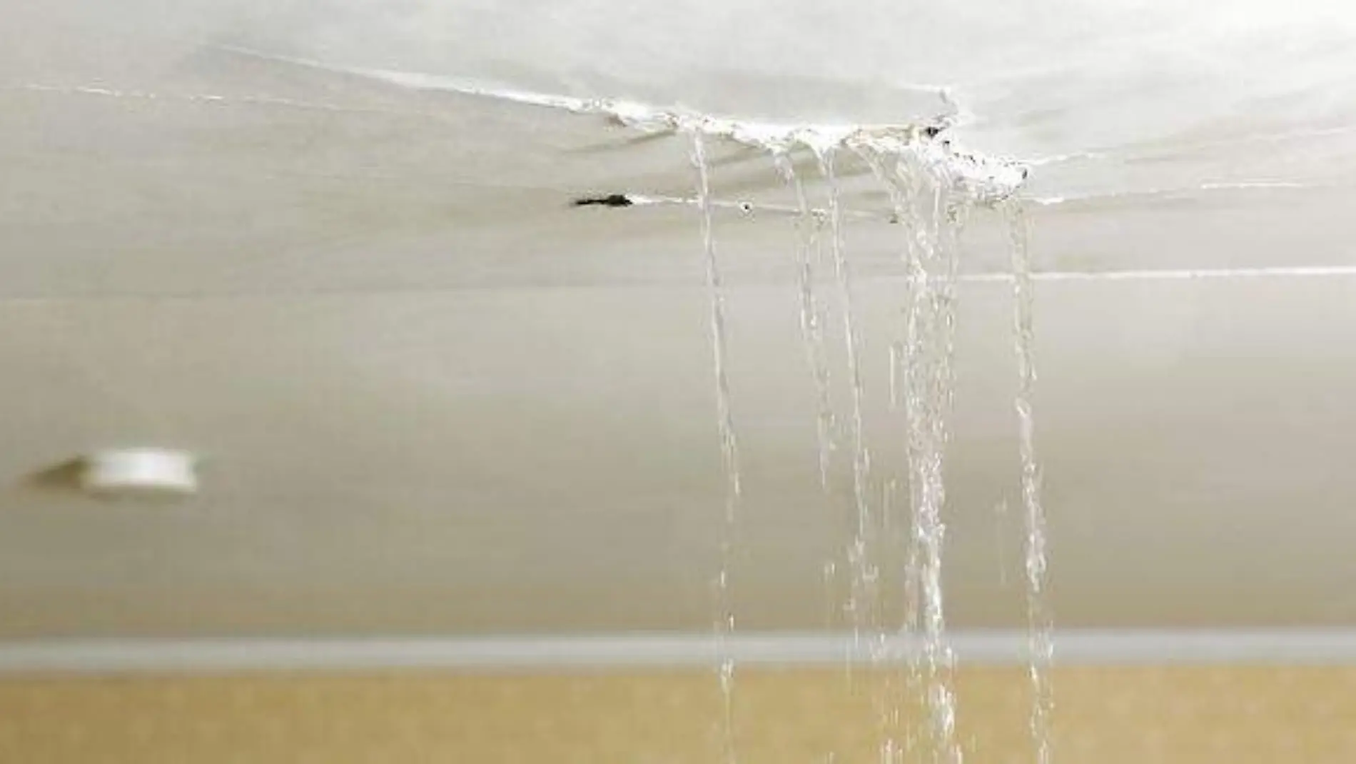 ceiling-leaking-water-into-living-room-royalty-free-image-1692809286