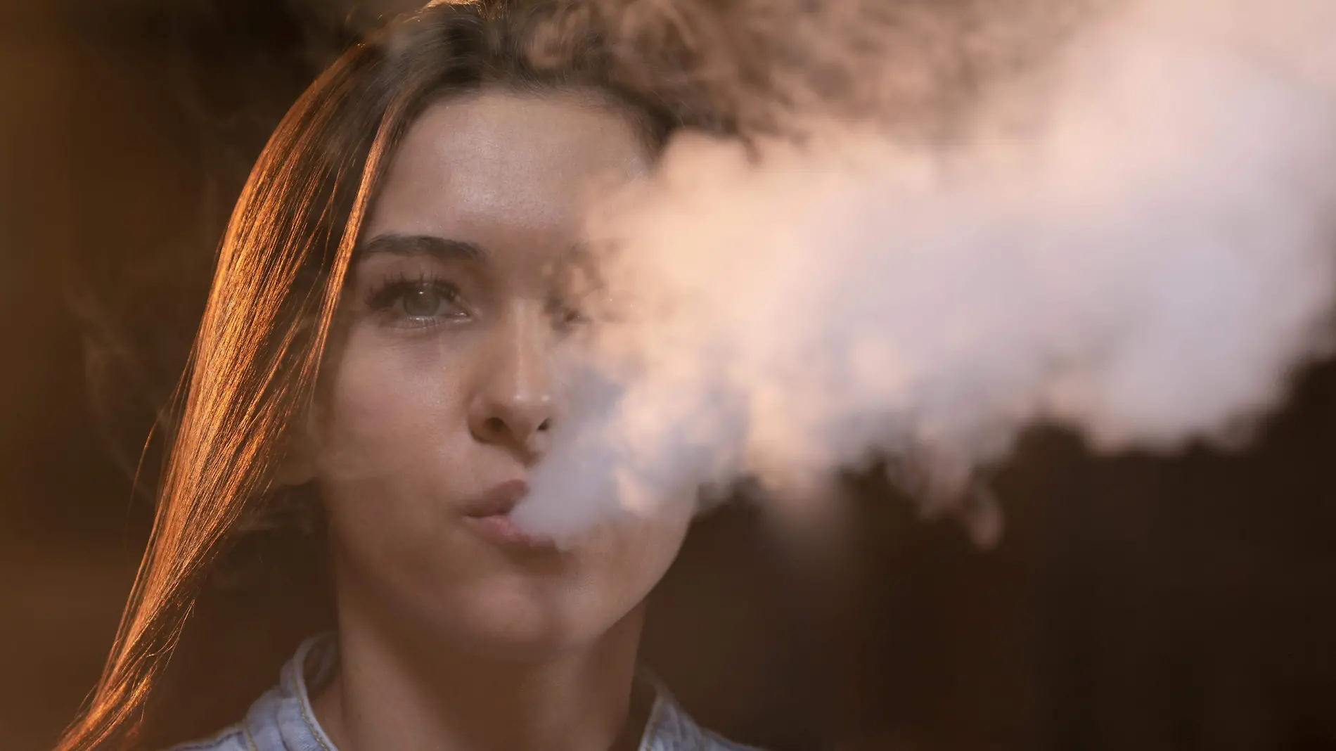 young-woman-vaping-from-hookah-in-bar