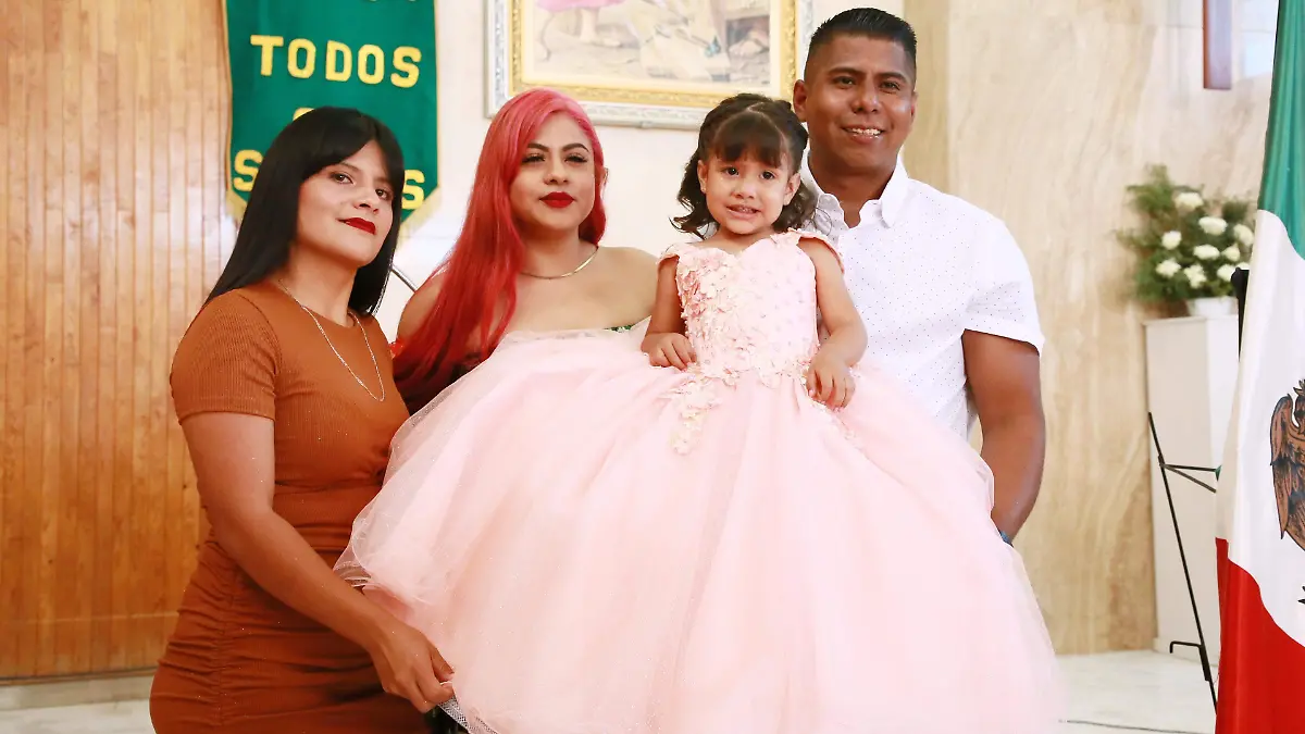 Con sus papás y su madrina