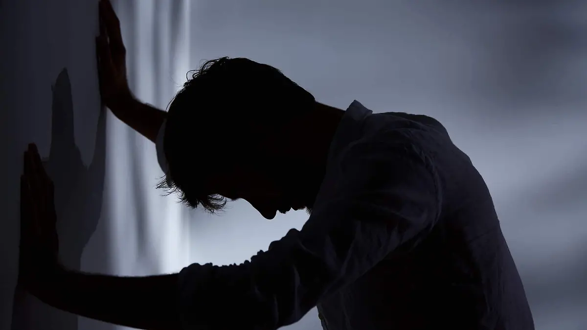 depressed-man-leaning-against-wall-iStock