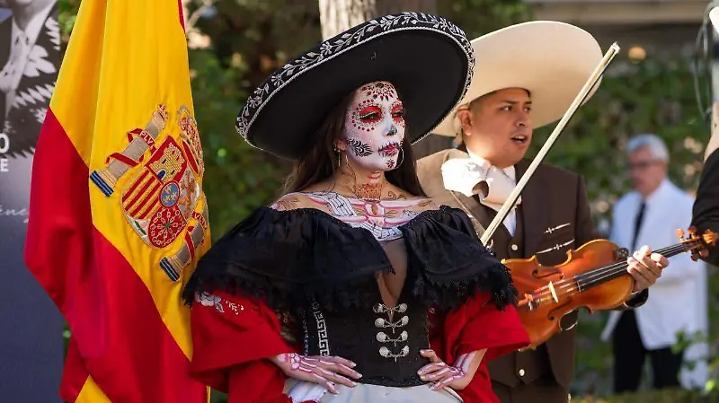 Artista caracterizada como catrina encabeza la ceremonia cultural en honor a José Alfredo Jiménez, acompañada por música tradicional mexicana y elementos representativos de México y España.