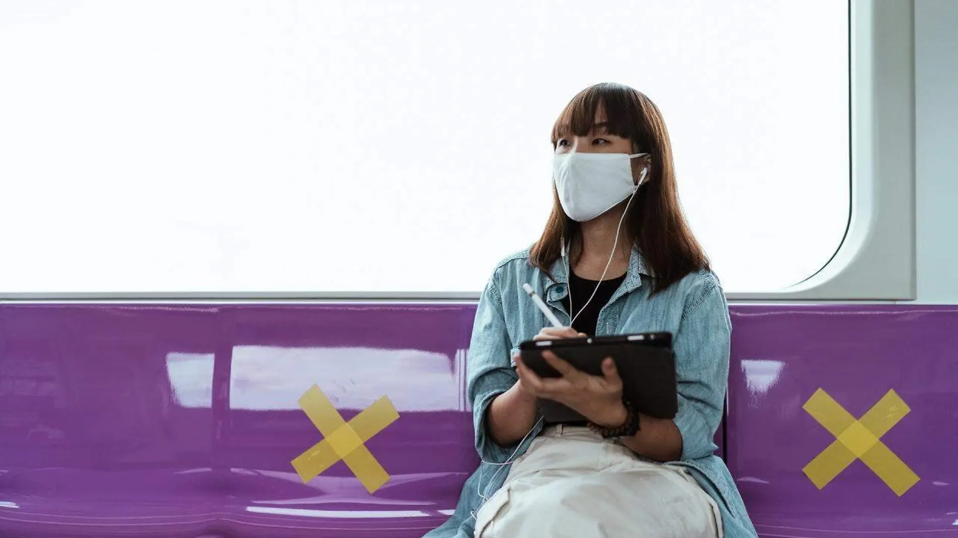 woman-wearing-a-face-mask-and-using-a-tablet-4429458