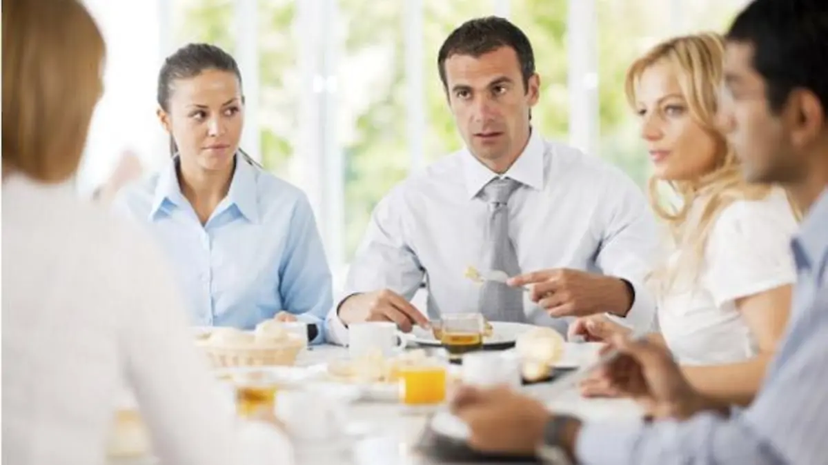 Group of successful businesspeople sitting and eating