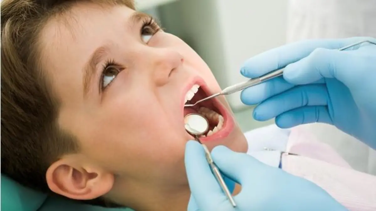 Close-up of little boy opening his mouth during dental checkup