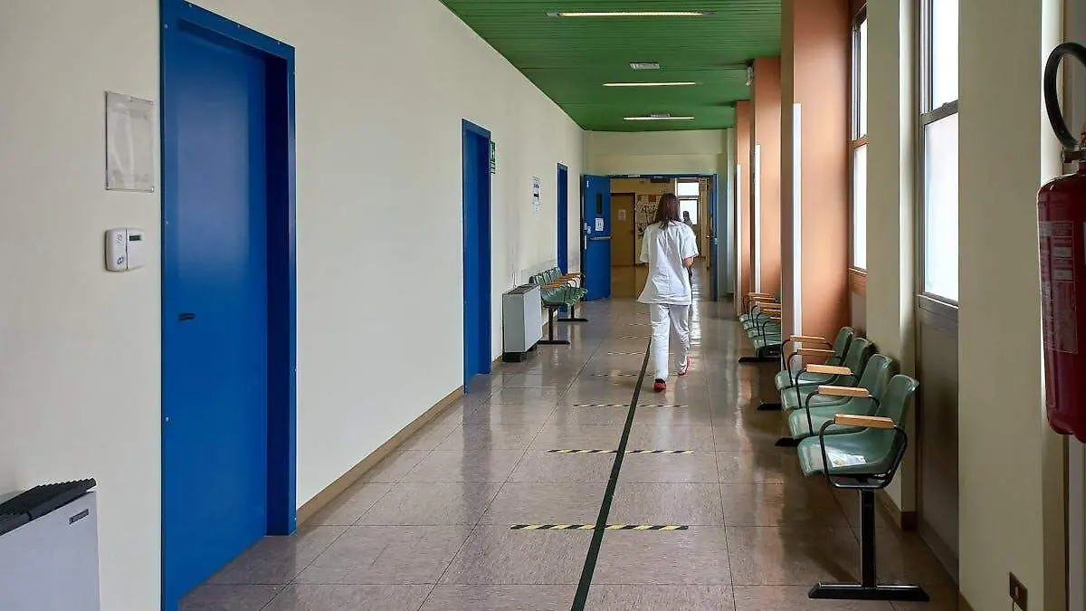 Personal medico caminando en pasillo de hospital