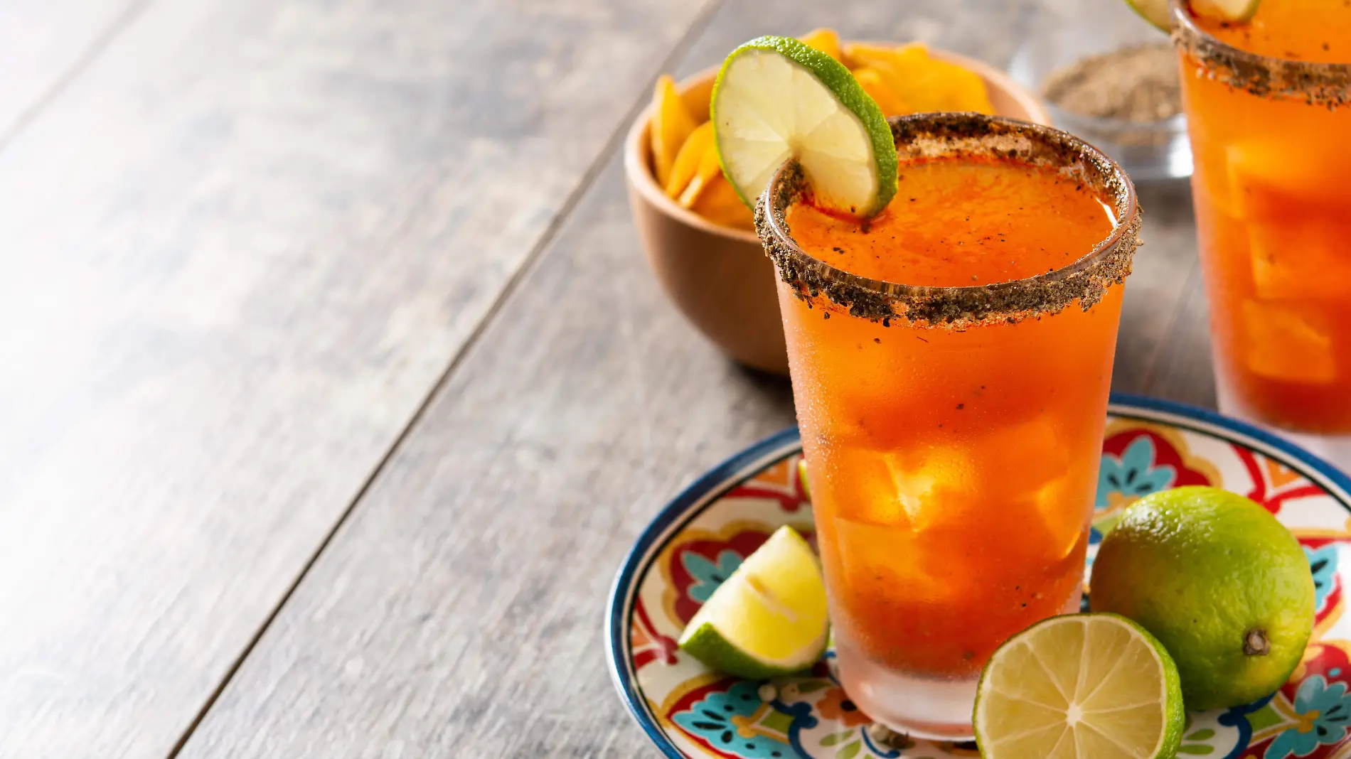 homemade-michelada-cocktail-with-beer-lime-juicehot-saucesalted-rim-tomato-juice