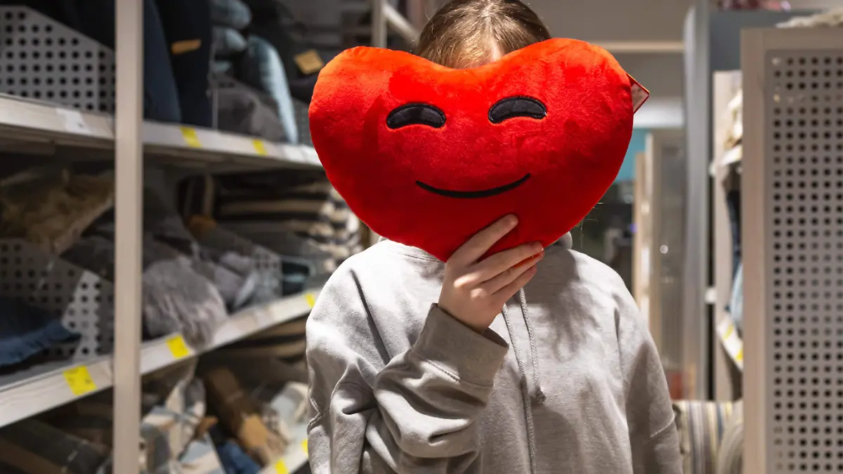 young-woman-holds-heartshaped-pillow-her-hands-store
