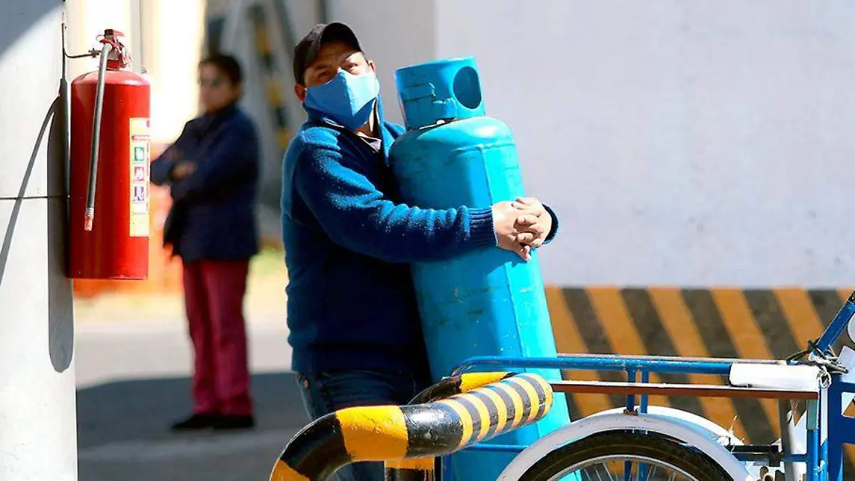 Persona cargando cilindro de gas LP