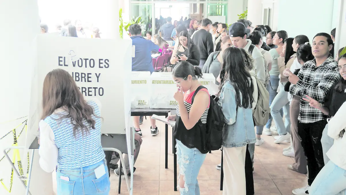 Alumnos universitarios emitiendo su voto
