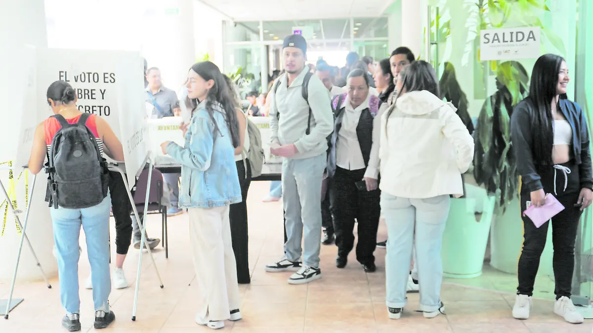 Alumnos universitarios emitiendo su voto