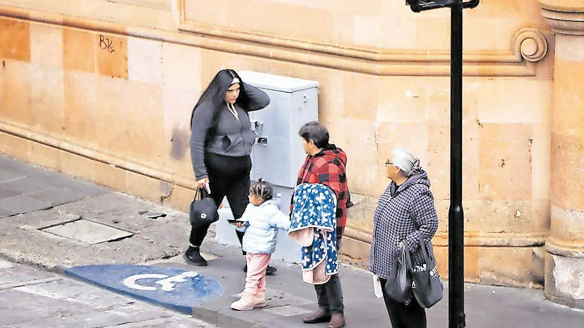 Personas vistiendo ropa abrigadora en el centro de la Ciudad de Zacatecas