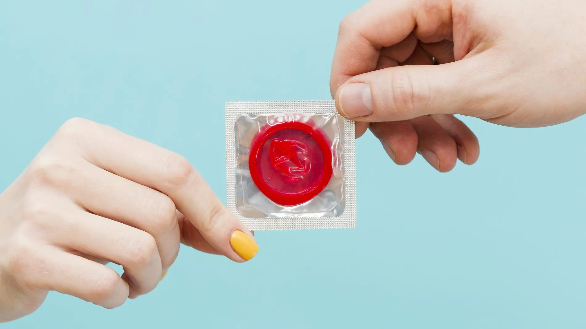 people-holding-red-condom