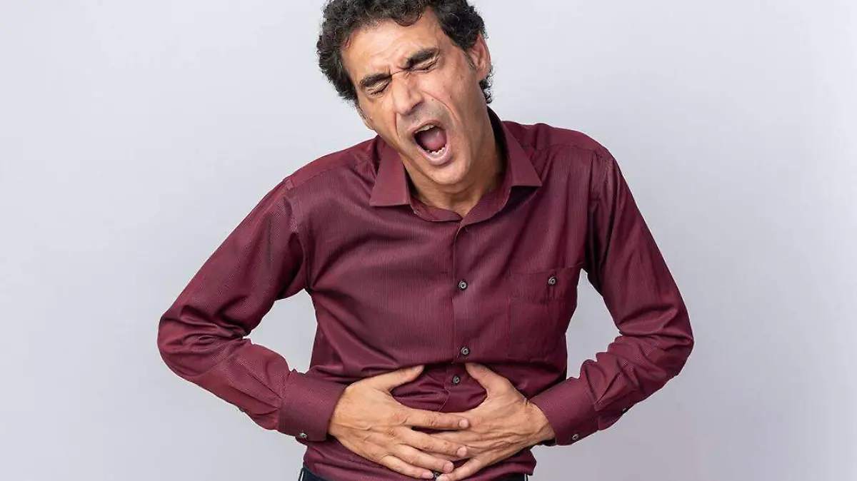 senior-man-purple-shirt-looking-unwell-touching-his-belly-feeling-pain-standing-white-background_141793-118788